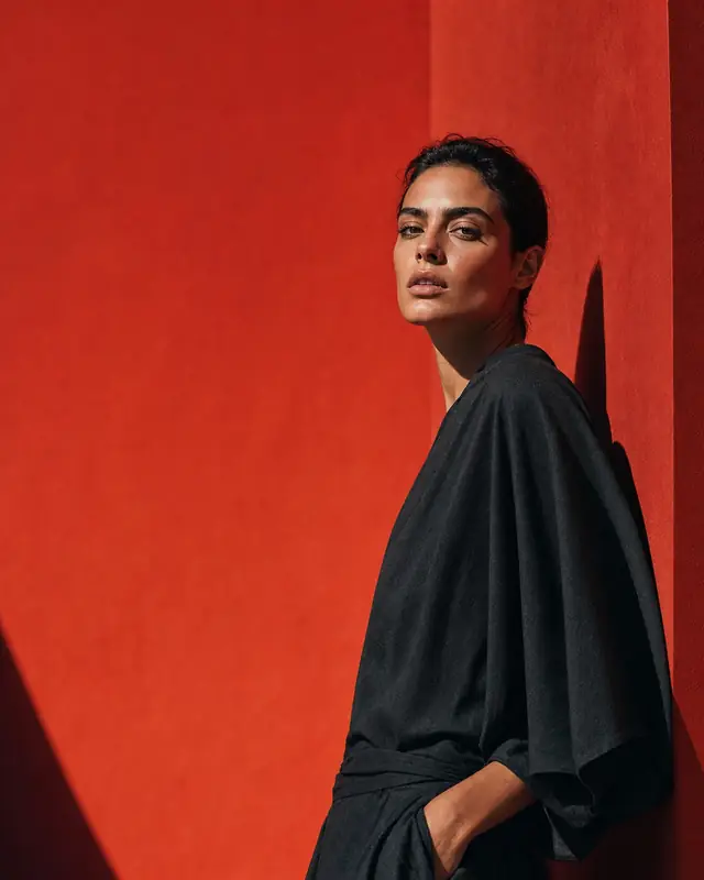Fashion portrait against a bold red studio set